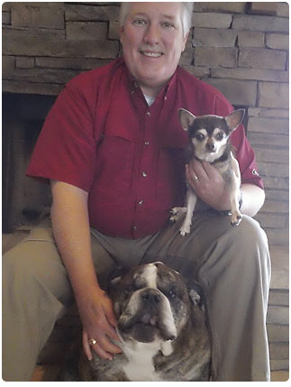 Jeff with Axel, our 9 year old bulldog, and Reese, our 15 year old Chihuahua.