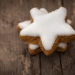 Cinnamon Stars christmas cookies with icing on rustic wooden background